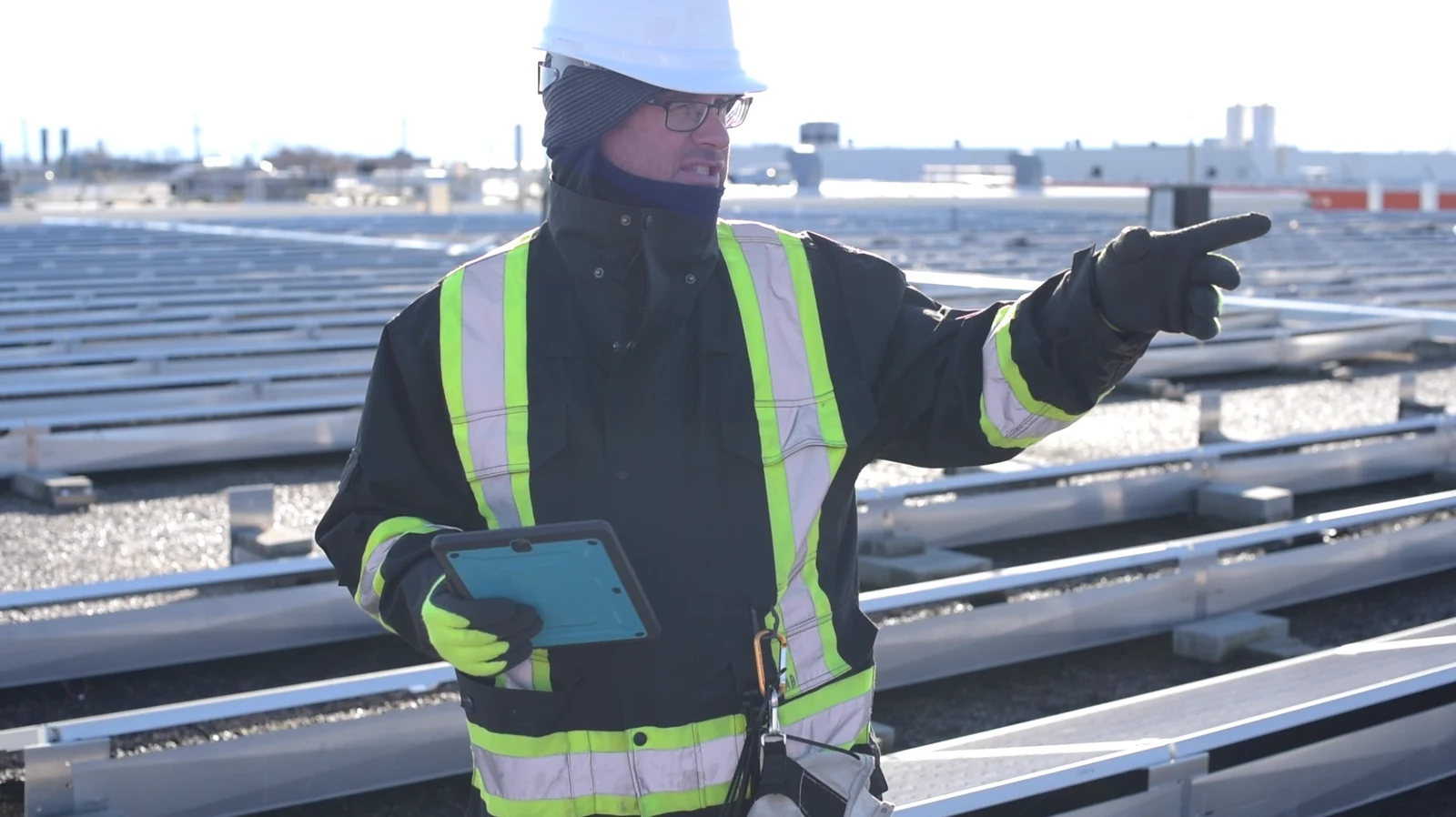 Zon Generation technician using a tablet during a rooftop maintenance briefing
