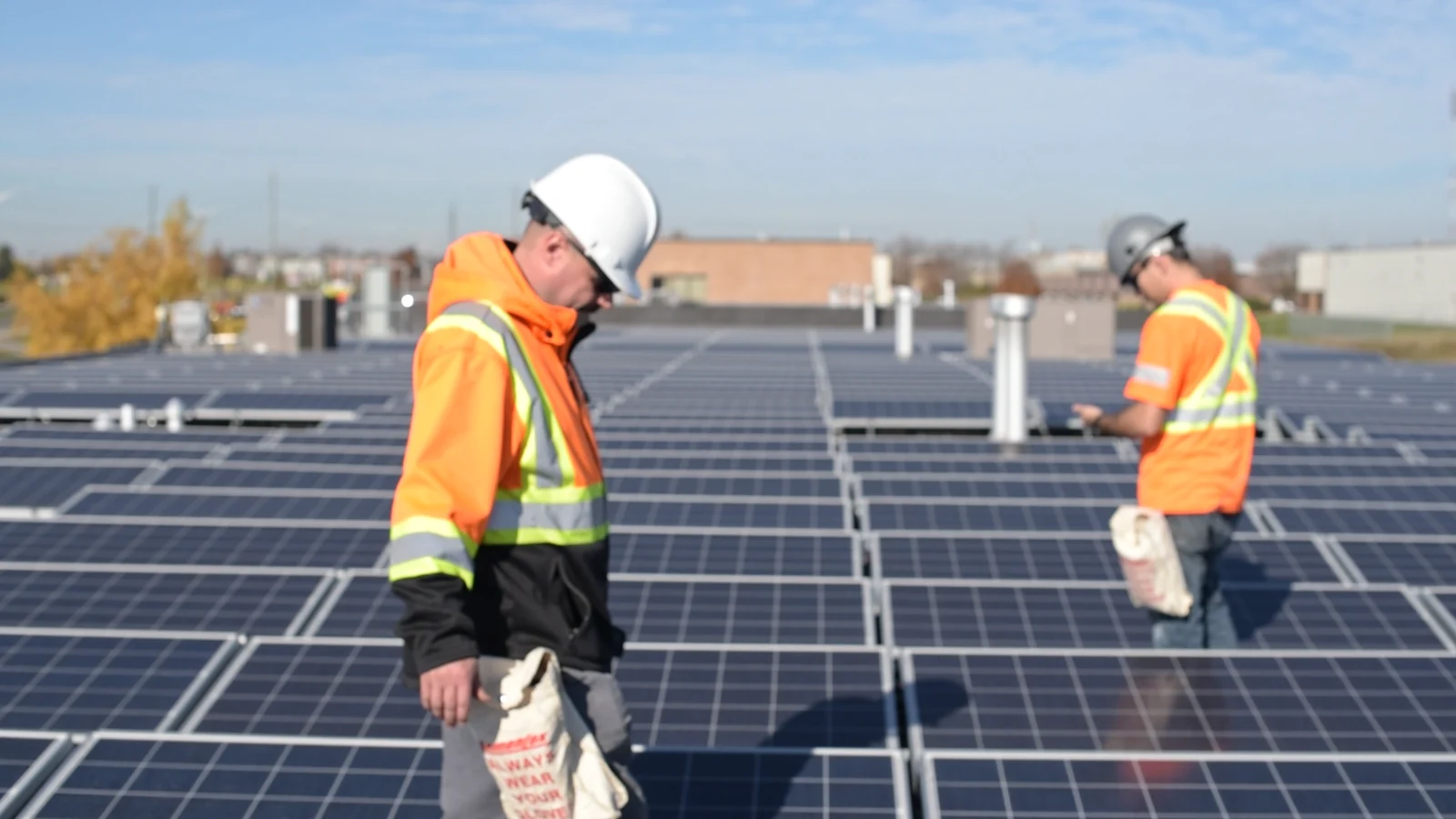 Two field technicians documenting work on an energy installation